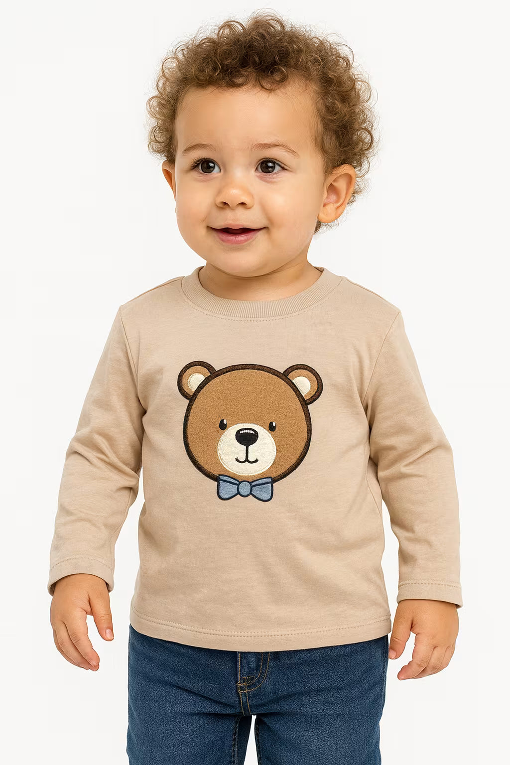 Child wearing a beige long-sleeve shirt with a bear graphic and bow tie on a white background