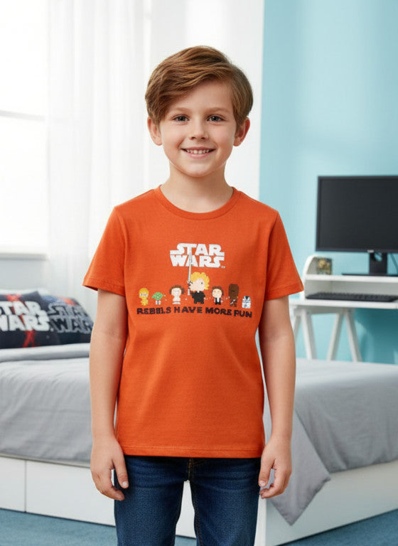Child wearing an orange 'Star Wars' t-shirt in a bedroom setting