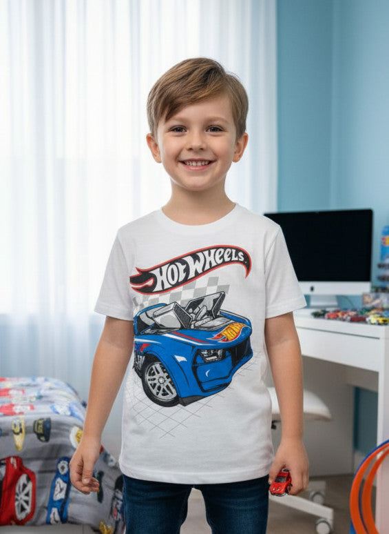 Child wearing a Hot Wheels t-shirt in a room with toys and furniture.