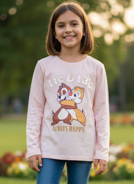 Child wearing a pink sweater with a cartoon character design outdoors.
